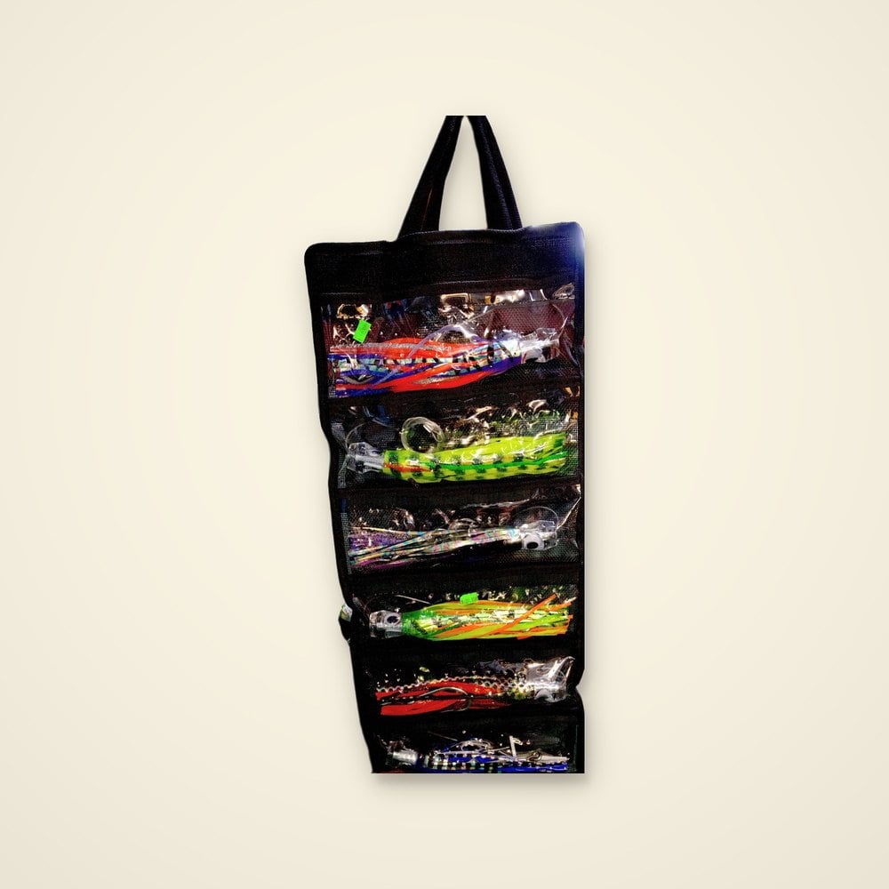 Black hanging lure bag with clear pockets of rigged trolling skirts in orange, green, purple, red and blue