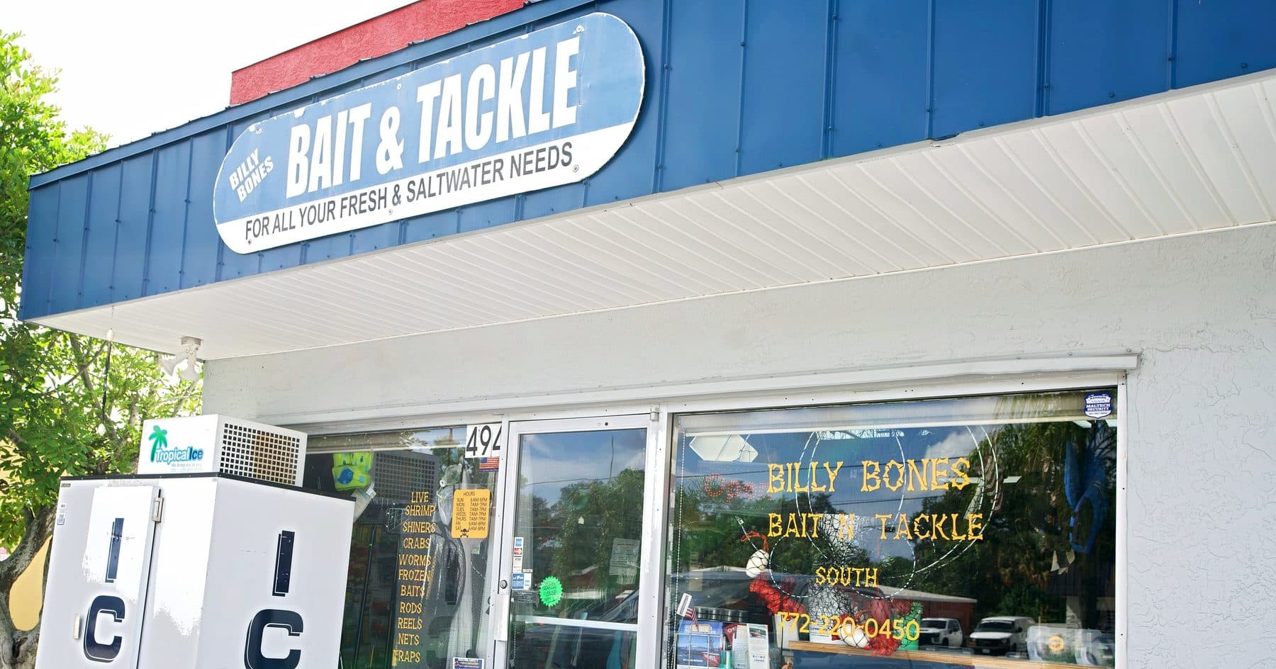 Billy Bones Bait & Tackle South storefront with a blue Bait & Tackle sign, a white ICE machine and the glass front door